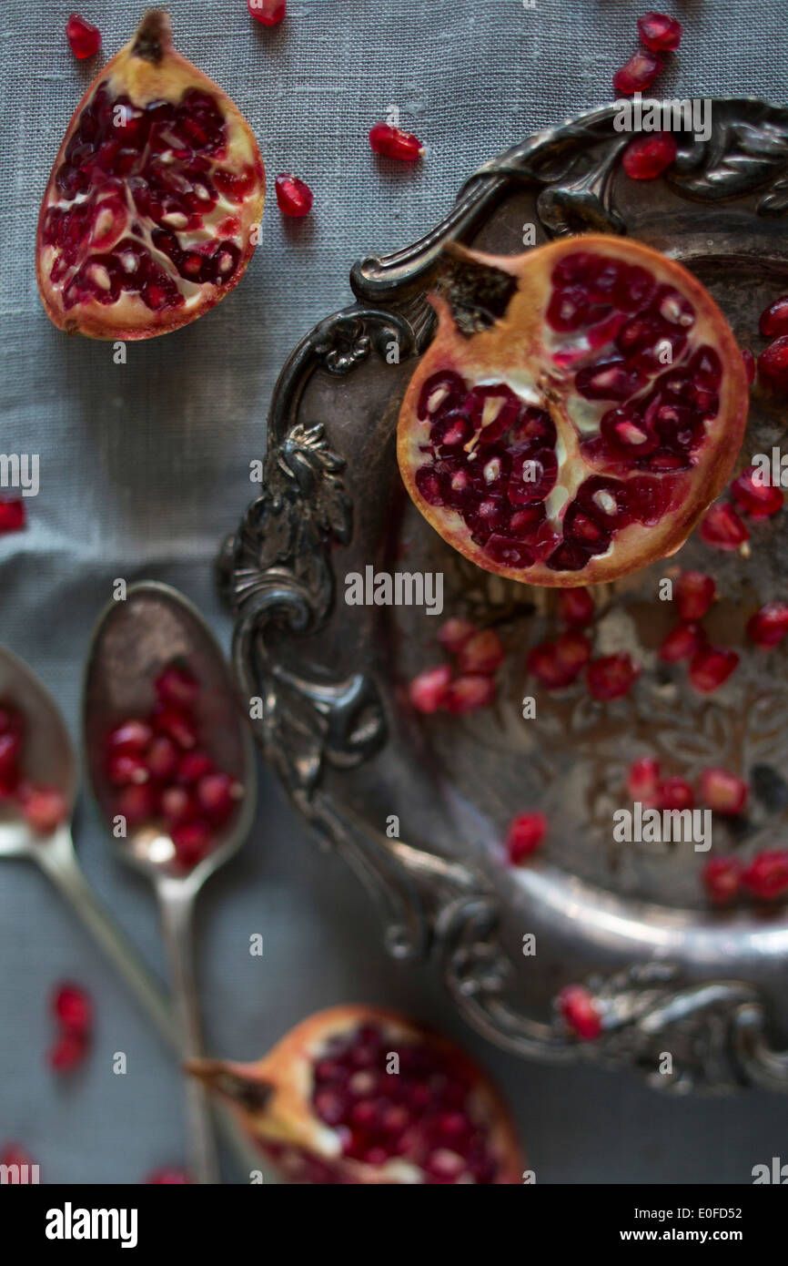 Pomegranate segments and seeds on a silver platter Stock Photo