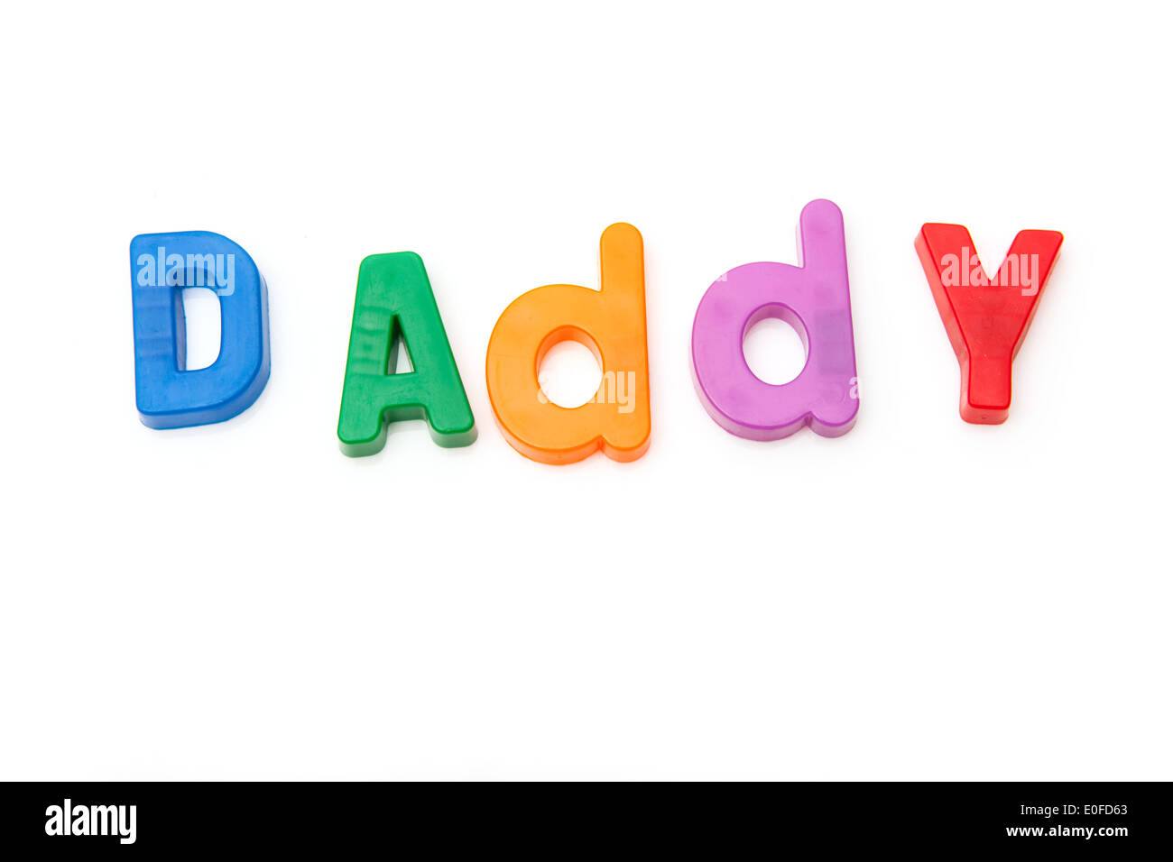Daddy written in magnetic letters on a white studio background. Stock Photo