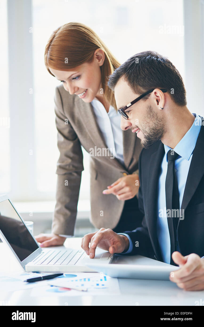 Using Computer With Partner Business partners using laptop hi-res stock photography and images - Alamy