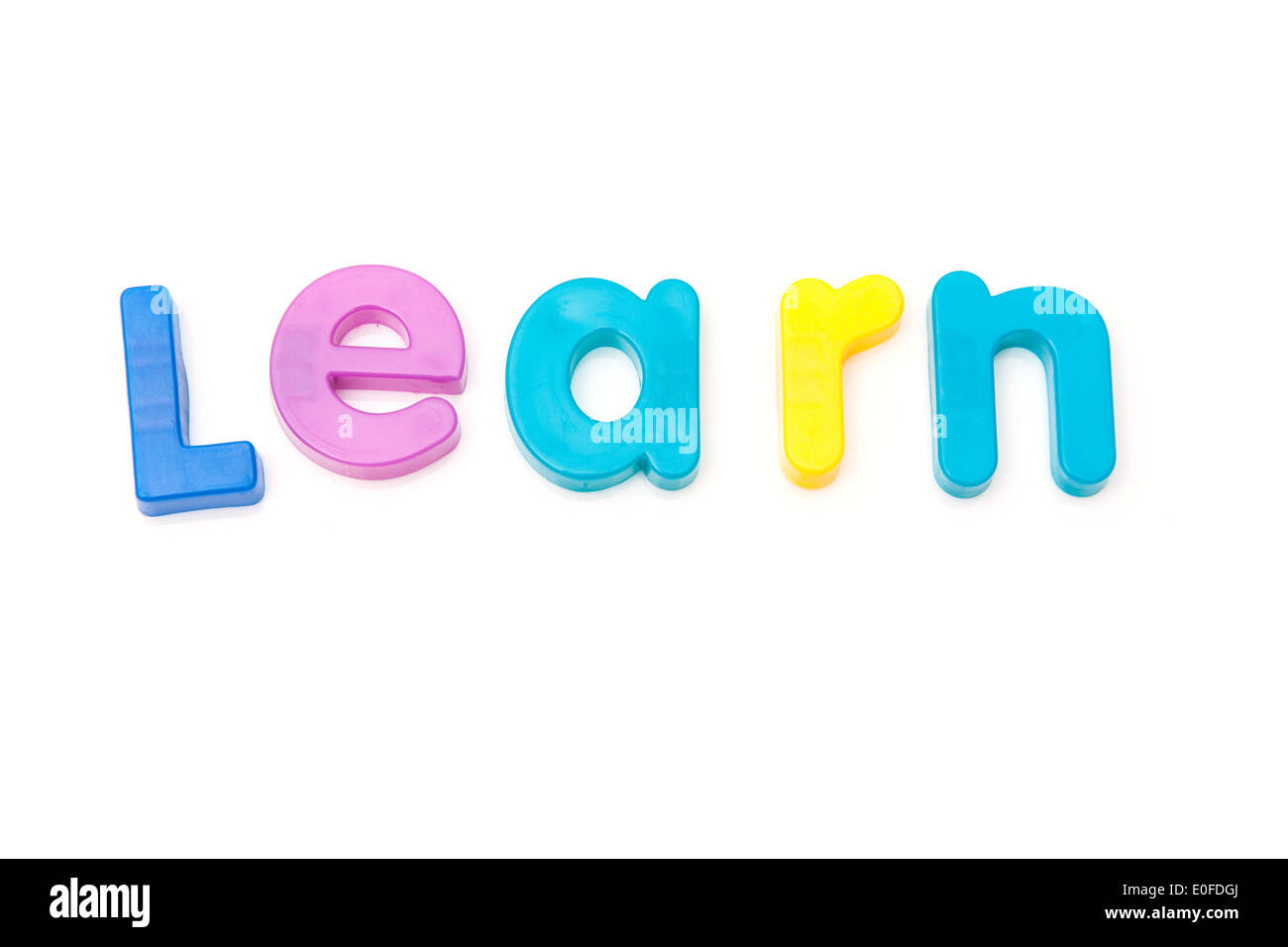Learn written in magnetic letters. on a white studio background. Stock Photo