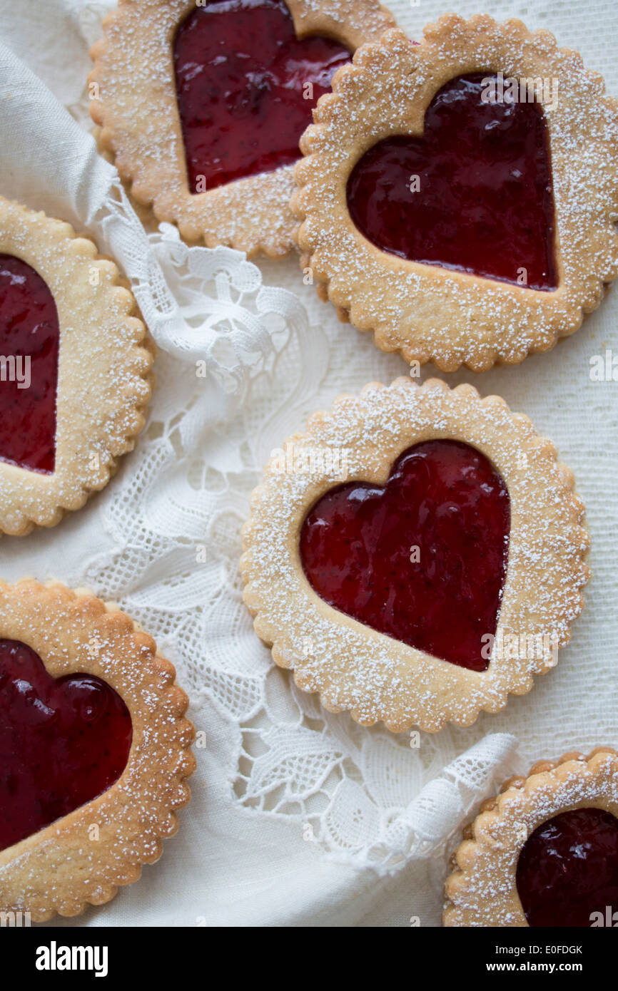 Strawberry Jam, heart shaped Linzer Biscuits on Lace Stock Photo