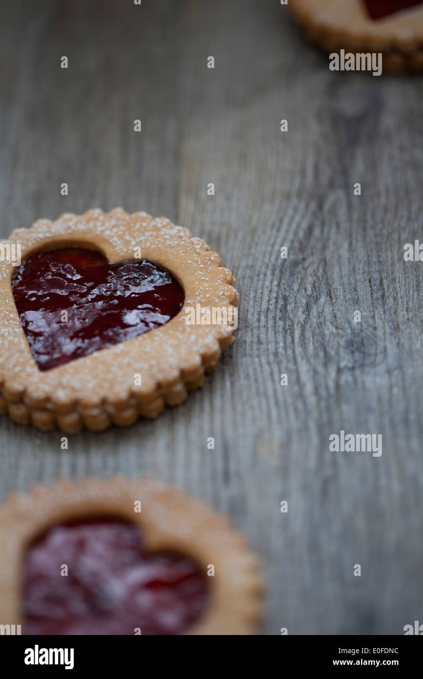 Strawberry Jam, heart shaped Linzer Biscuits on Wood Stock Photo