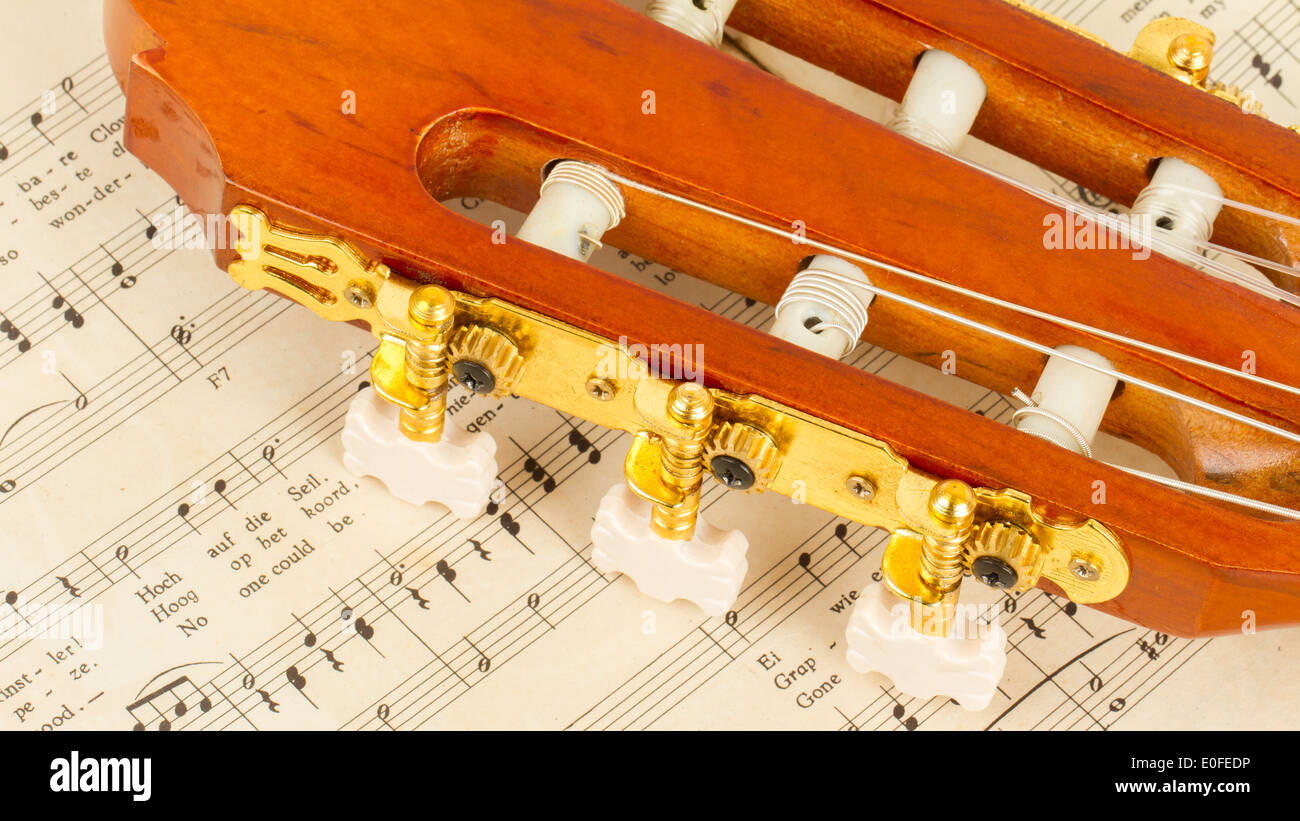 Old music sheet and a guitar isolated Stock Photo