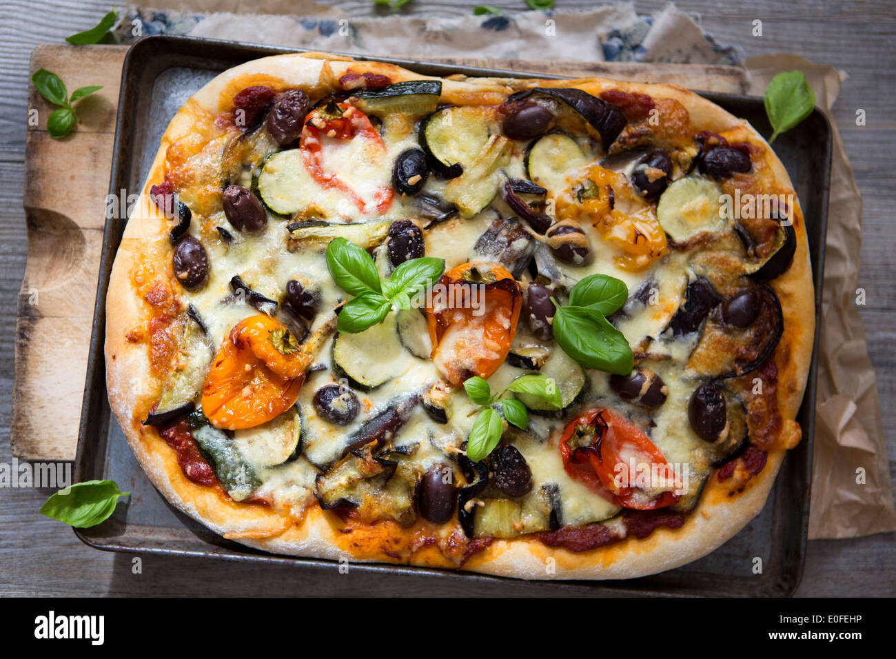 Homemade Roasted Vegetable Pizza with Olives, Basil and Peppers Stock Photo