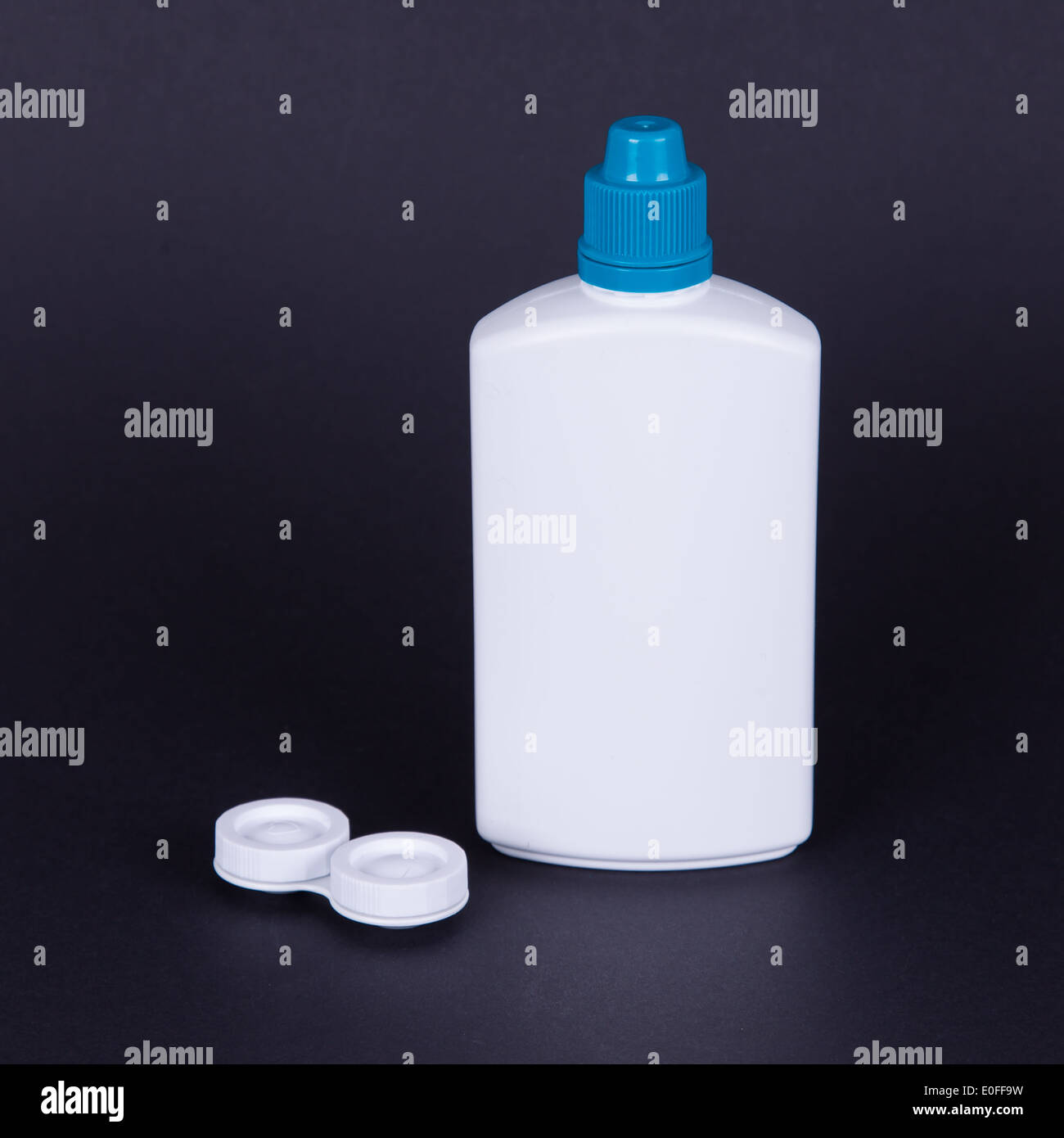 Lens casing and bottle of water isolated on black, contact lenses Stock