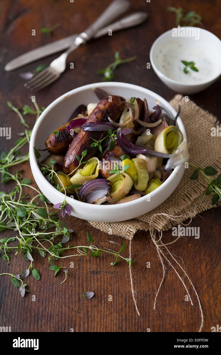 Sausage, Leek, Red Onion & Thyme in a bowl with Sour Cream Stock Photo