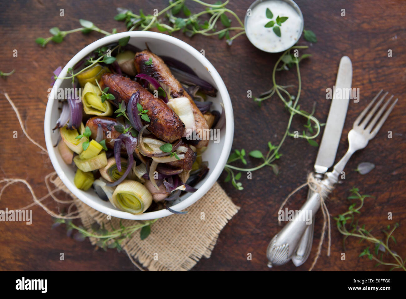Sausage, Leek, Red Onion & Thyme in a bowl with Sour Cream Stock Photo