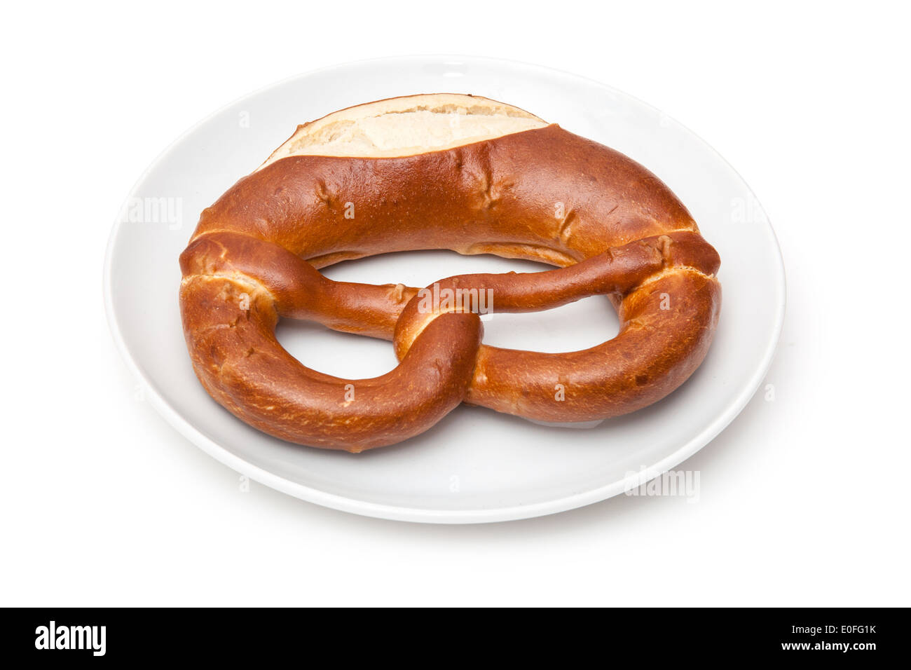 Traditional German Pretzel on a white plate. Stock Photo