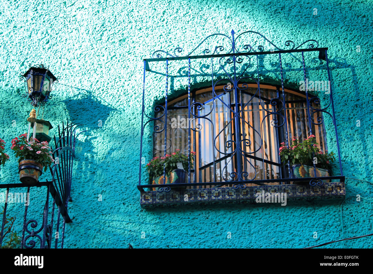 Turquoise blue wall, wrought iron window railing, La Condesa, Mexico City Stock Photo
