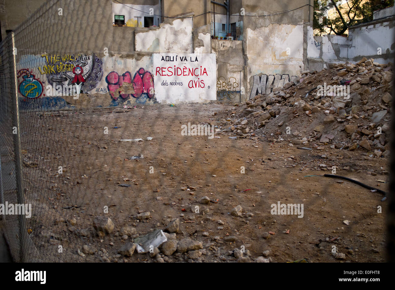 Urban transformation in the district of Ciutat Vella in Barcelona. A plot with graffiti claiming the area for a residence . Stock Photo