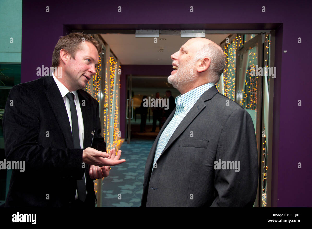 Two men talking networking at a business conference social event Stock Photo