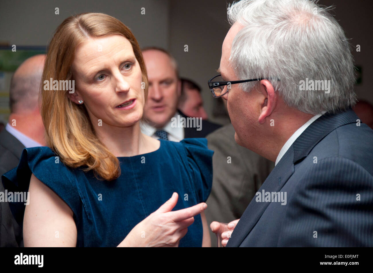Man and woman talking networking at a business conference social event Stock Photo