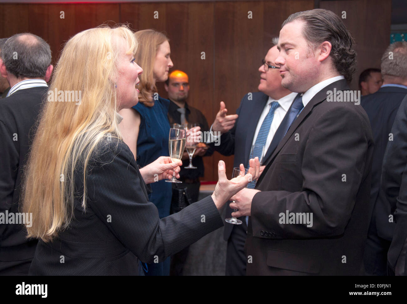 Men and women talking networking at a business conference social event Stock Photo