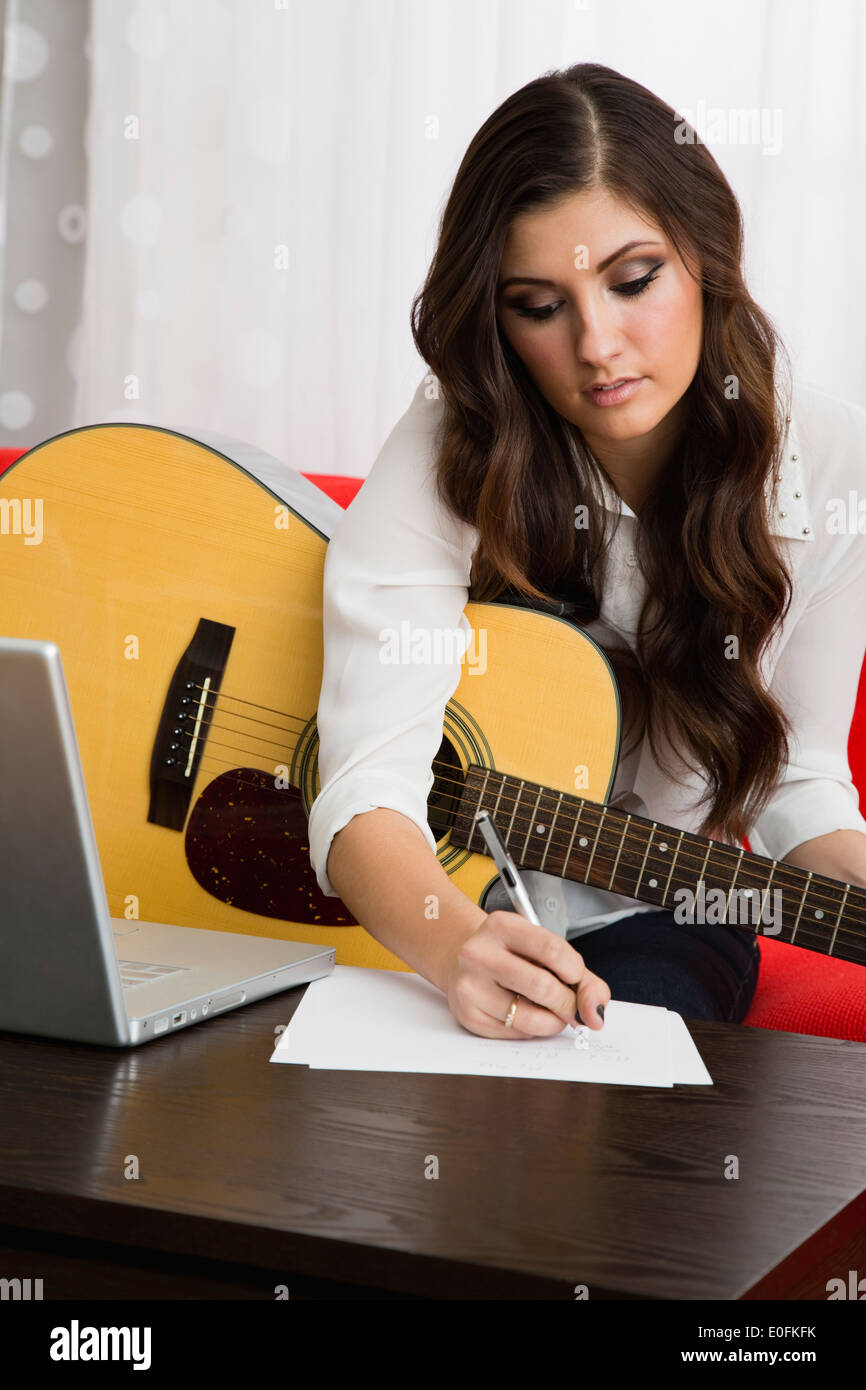 Female composer playing guitar Stock Photo Alamy