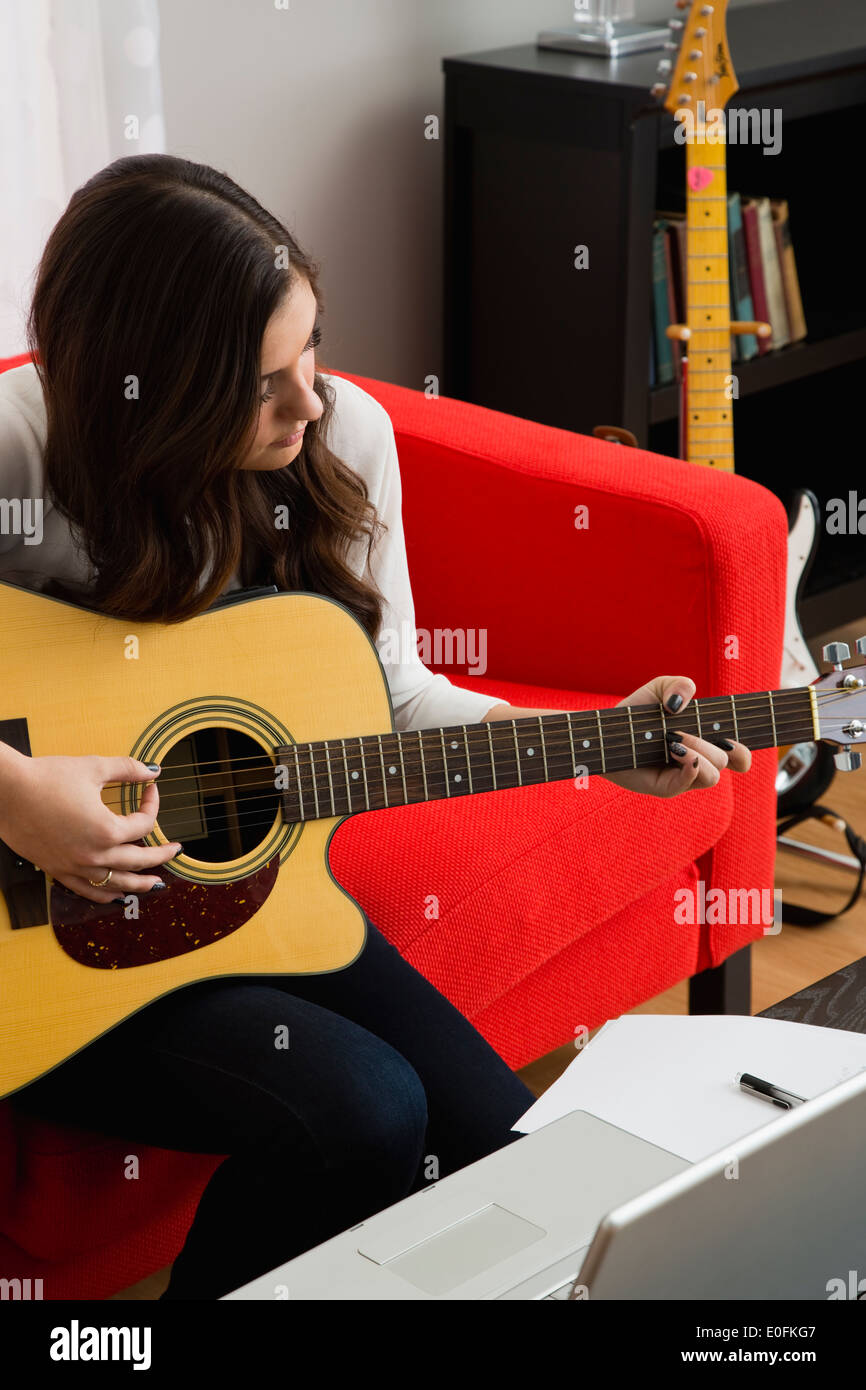 Female composer playing guitar Stock Photo Alamy