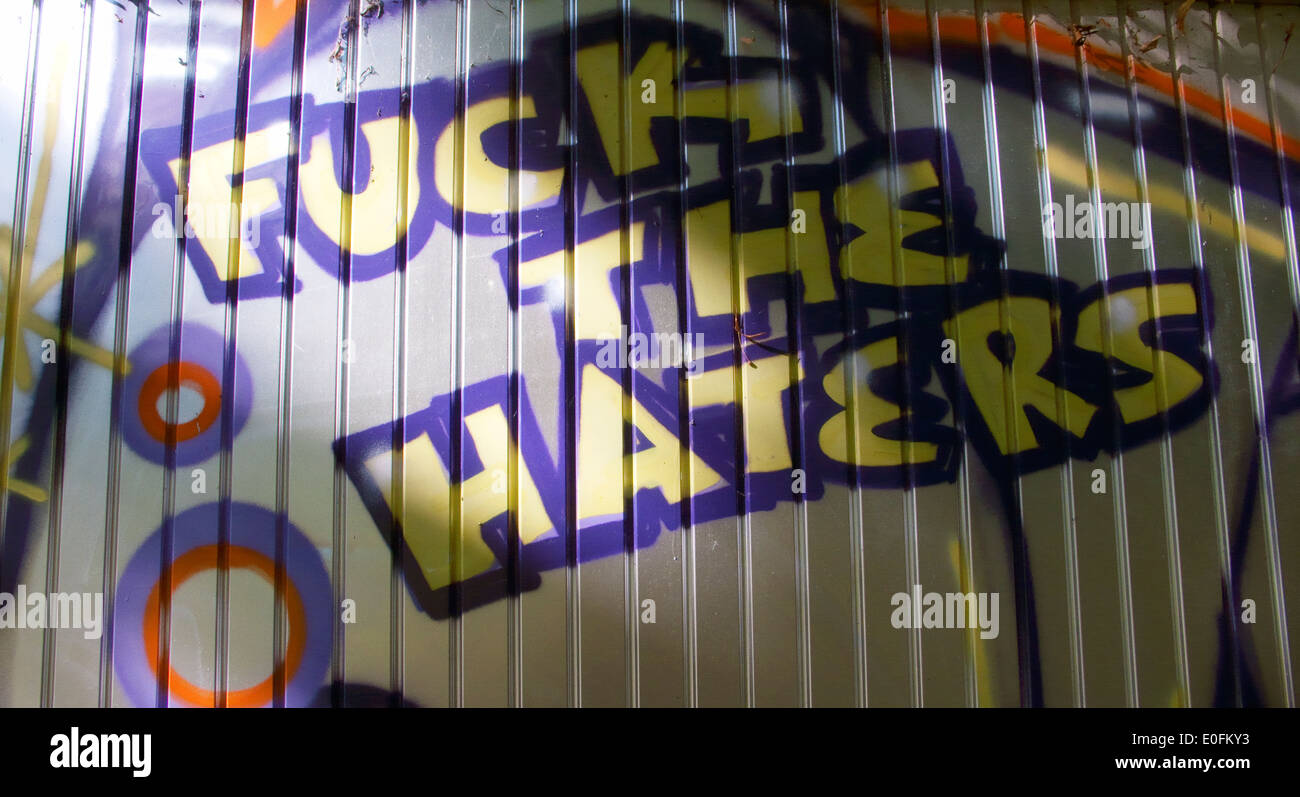 Graffiti on a wall saying fuck the haters football anon anonymous clour statement artist Stock Photo