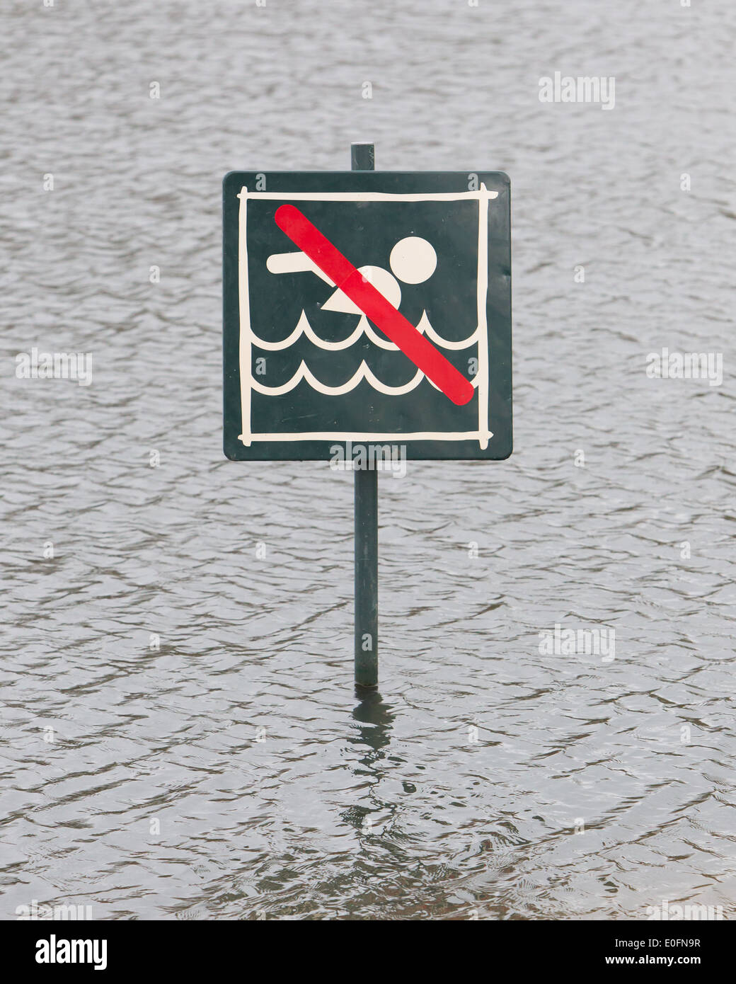 Warning sign at a lake, Caution No Swimming allowed Stock Photo