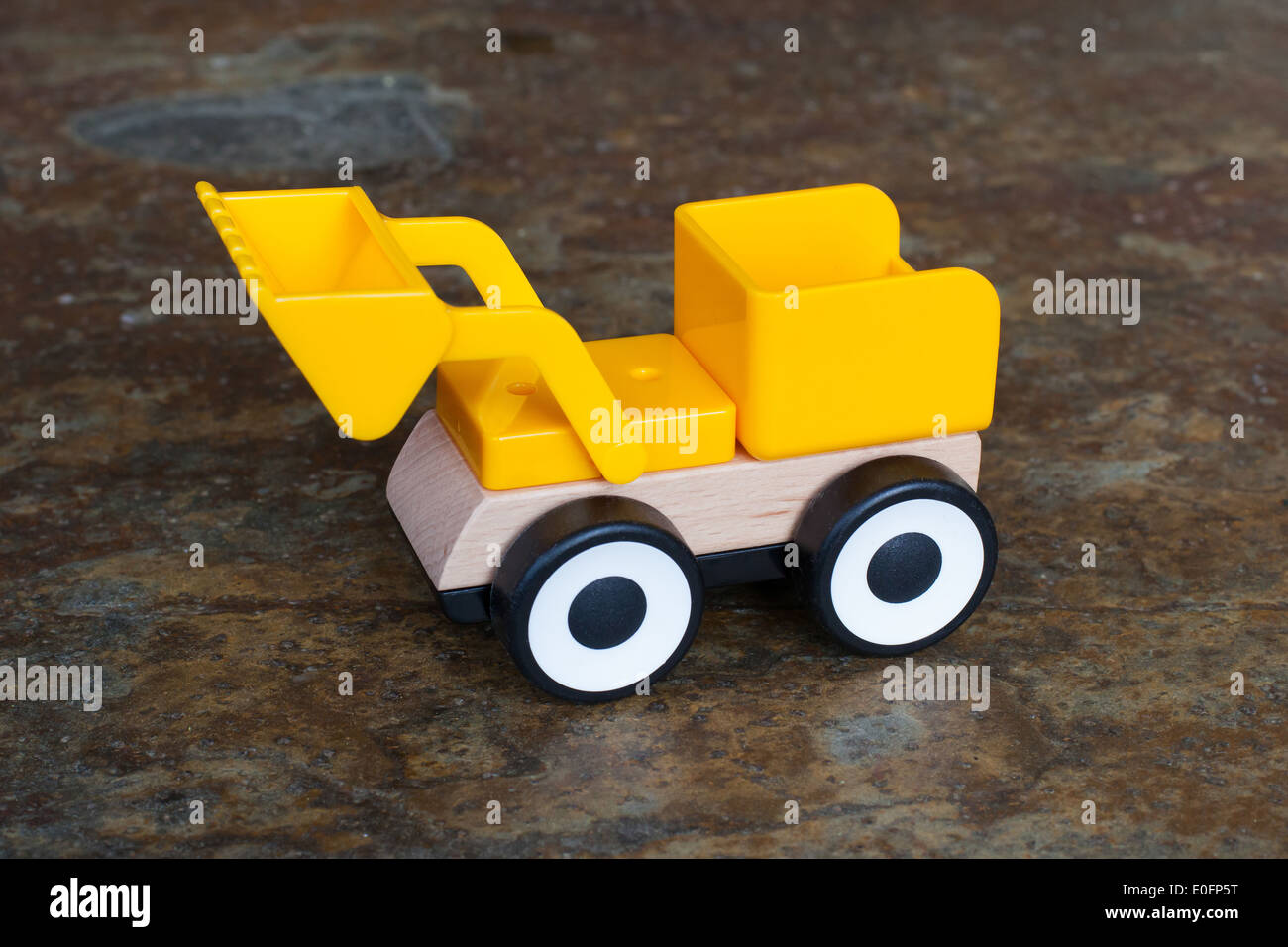 Simple wheel dozer toy, plastic and wood Stock Photo