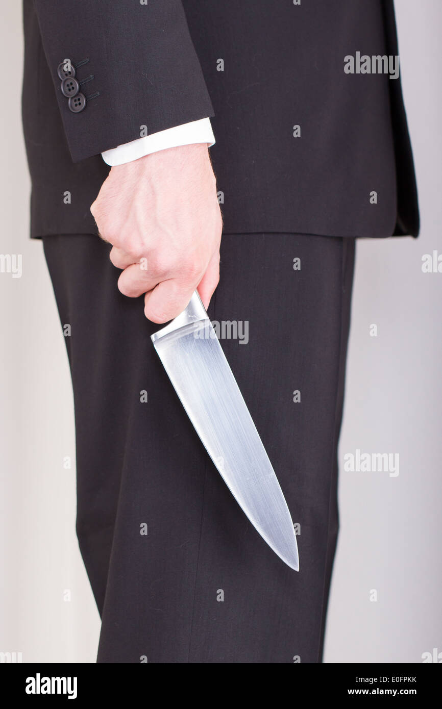 Man with knife, business suit, focus on the knife Stock Photo Alamy