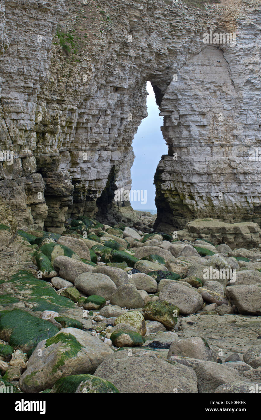 View through the eroded cliff arch. Stock Photo
