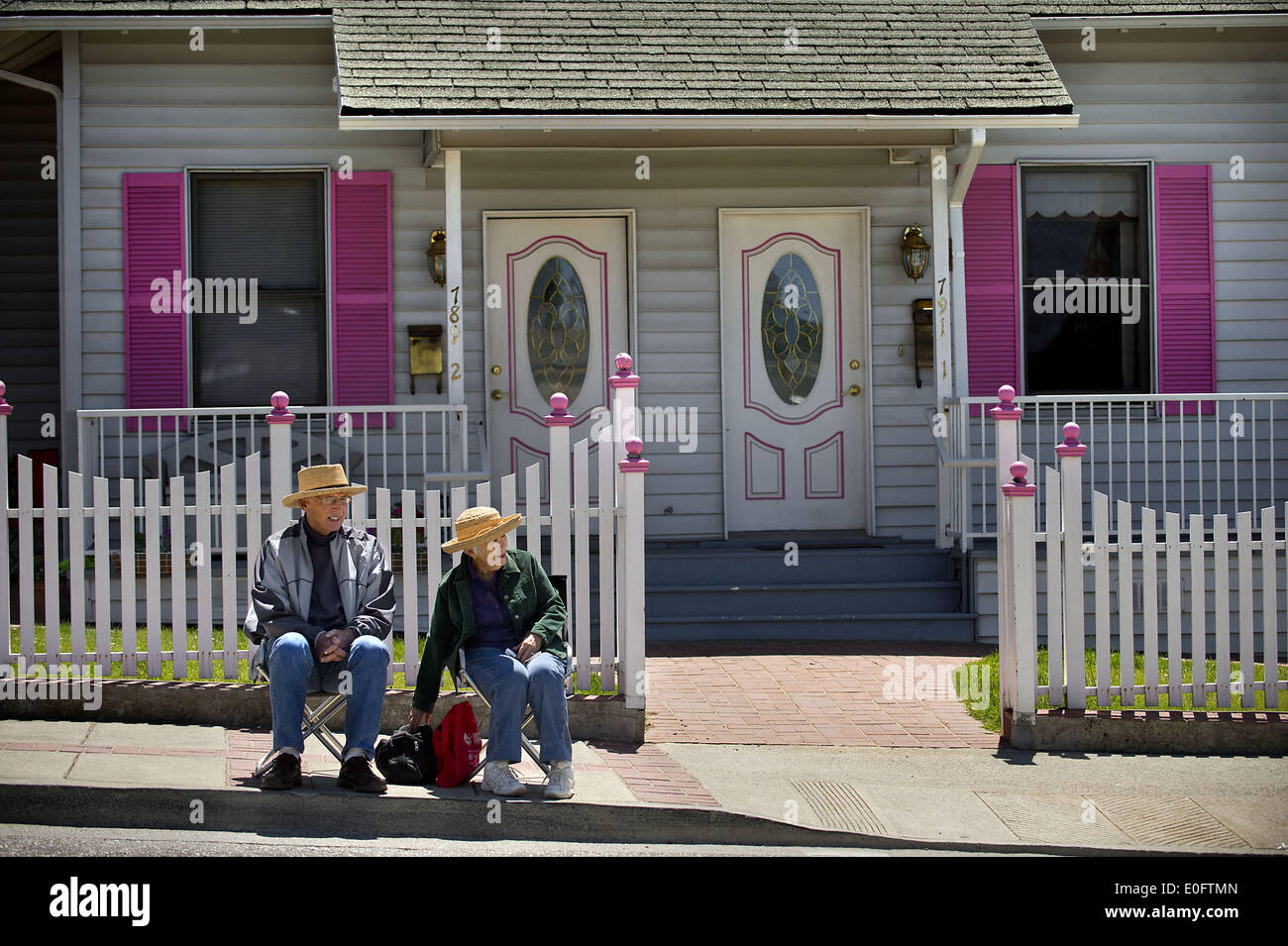 Sacramento, California, USA. 11th May, 2014. Bill Martin, left, and his wife Linda Martin of Auburn sit on the sidewalk on Lincoln Way during stage 1 of the Amgen Tour of California cycling event in Auburn on Sunday, May 11, 2014. © Randall Benton/Sacramento Bee/ZUMAPRESS.com/Alamy Live News Stock Photo