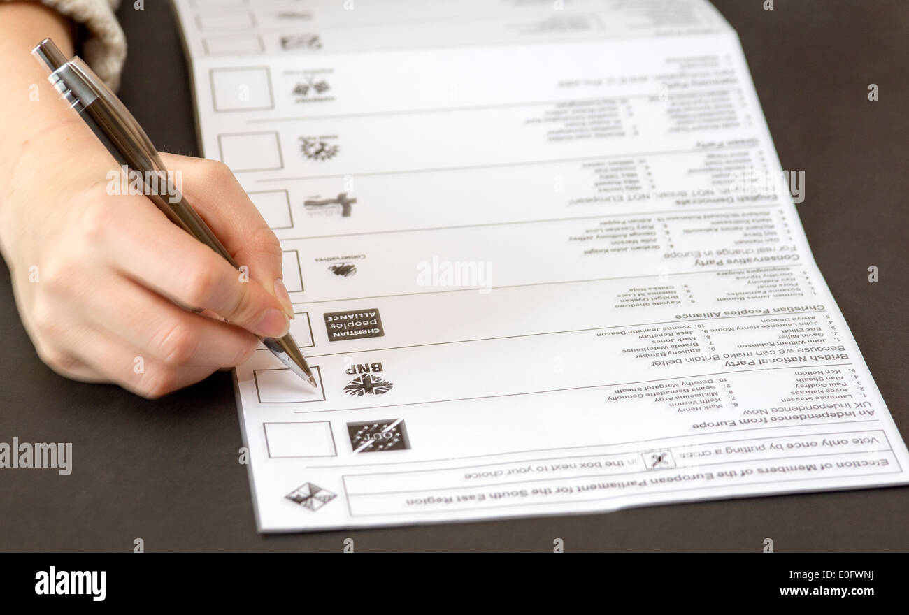 Putting cross on postal ballot paper in European Parliament elections May 2014 Stock Photo
