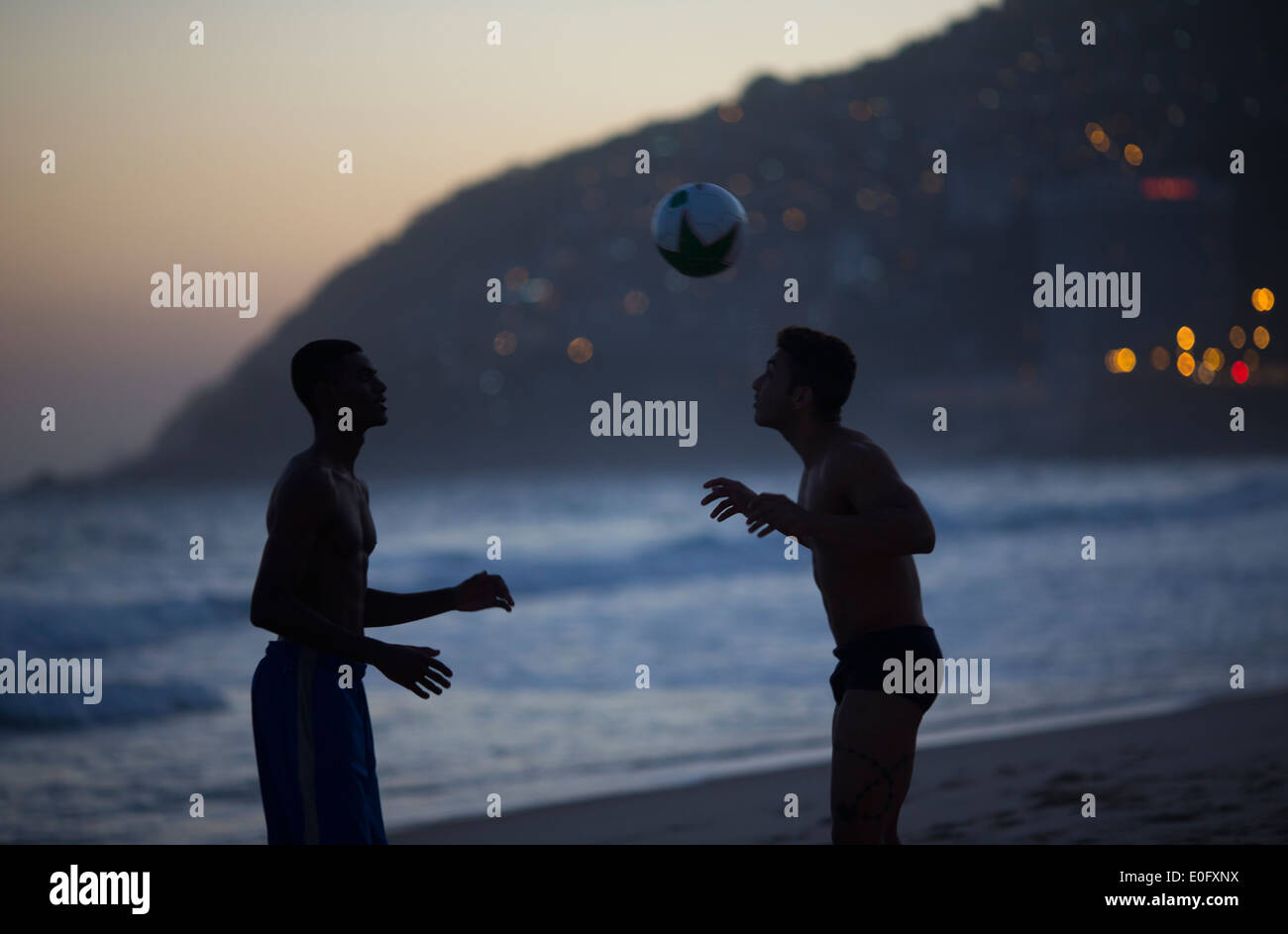 Brazil men playing football on Ipanema and Leblon beach, Rio de Janeiro Stock Photo