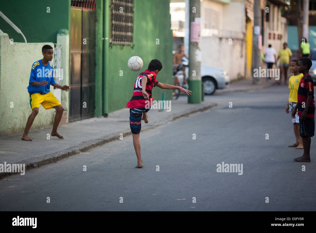 Brazilian boys playing football in a favela street of Rio de Janeiro Stock Photo