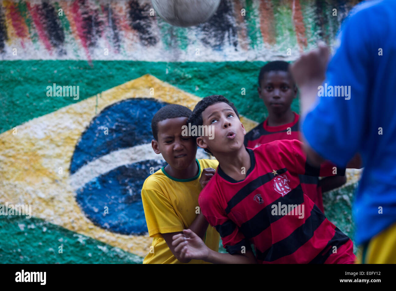 Brazilian boys playing football in a favela street of Rio de Janeiro Stock Photo