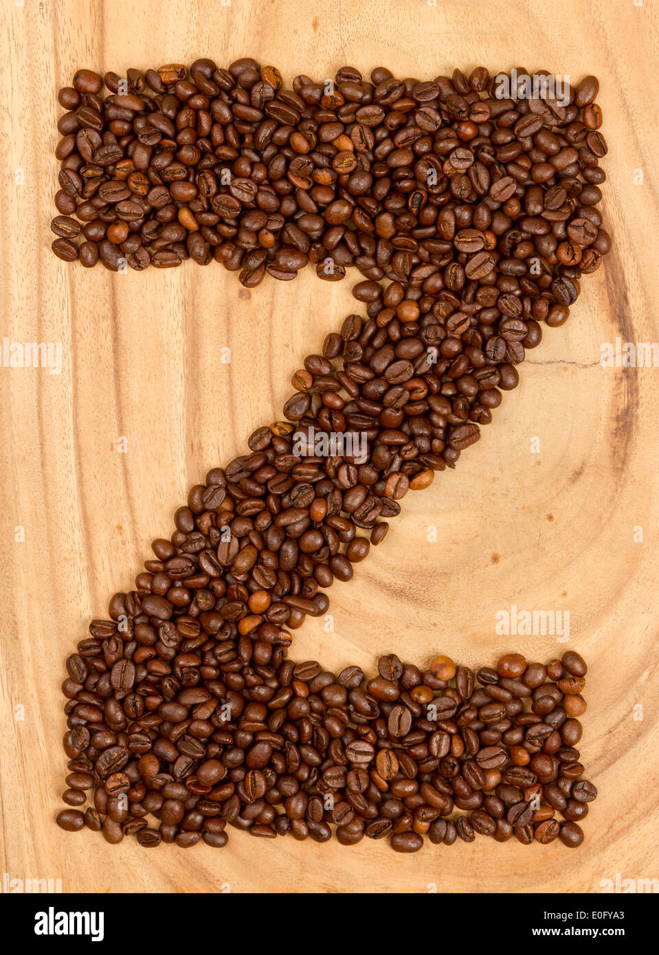 Letter Z, alphabet from coffee beans. isolated on wood Stock Photo