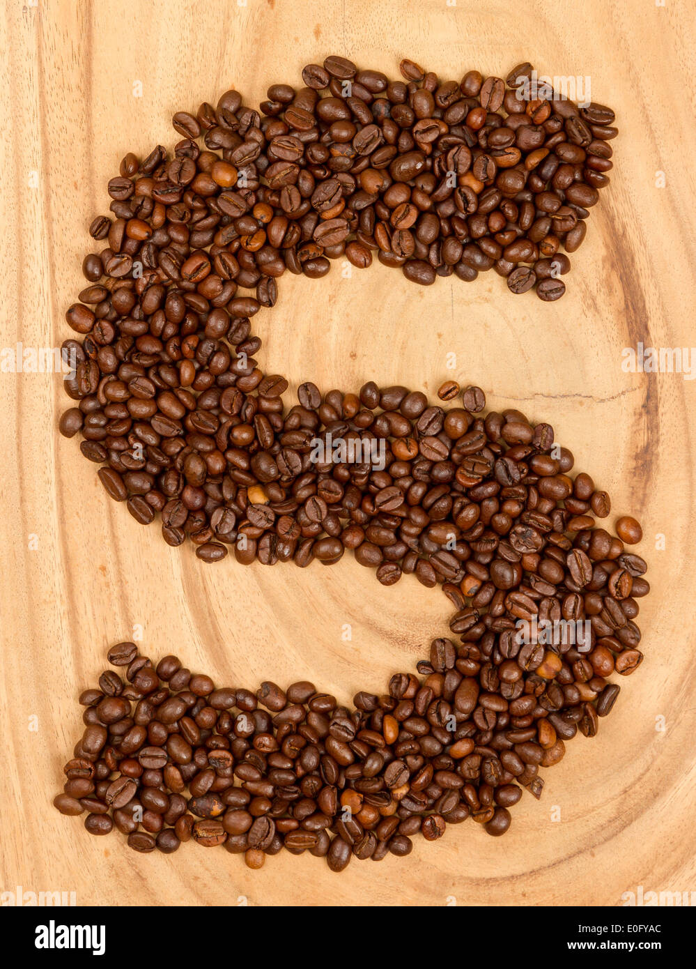 Letter S, alphabet from coffee beans. isolated on wood Stock Photo