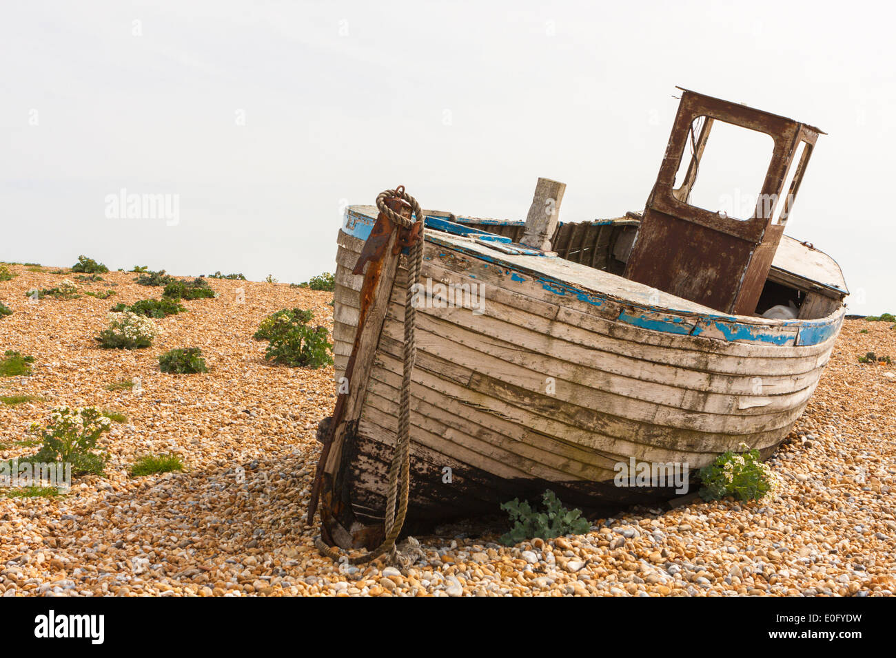 Abandoned fishing boat on a shingle beach at Dungeness Kent UK Stock ...