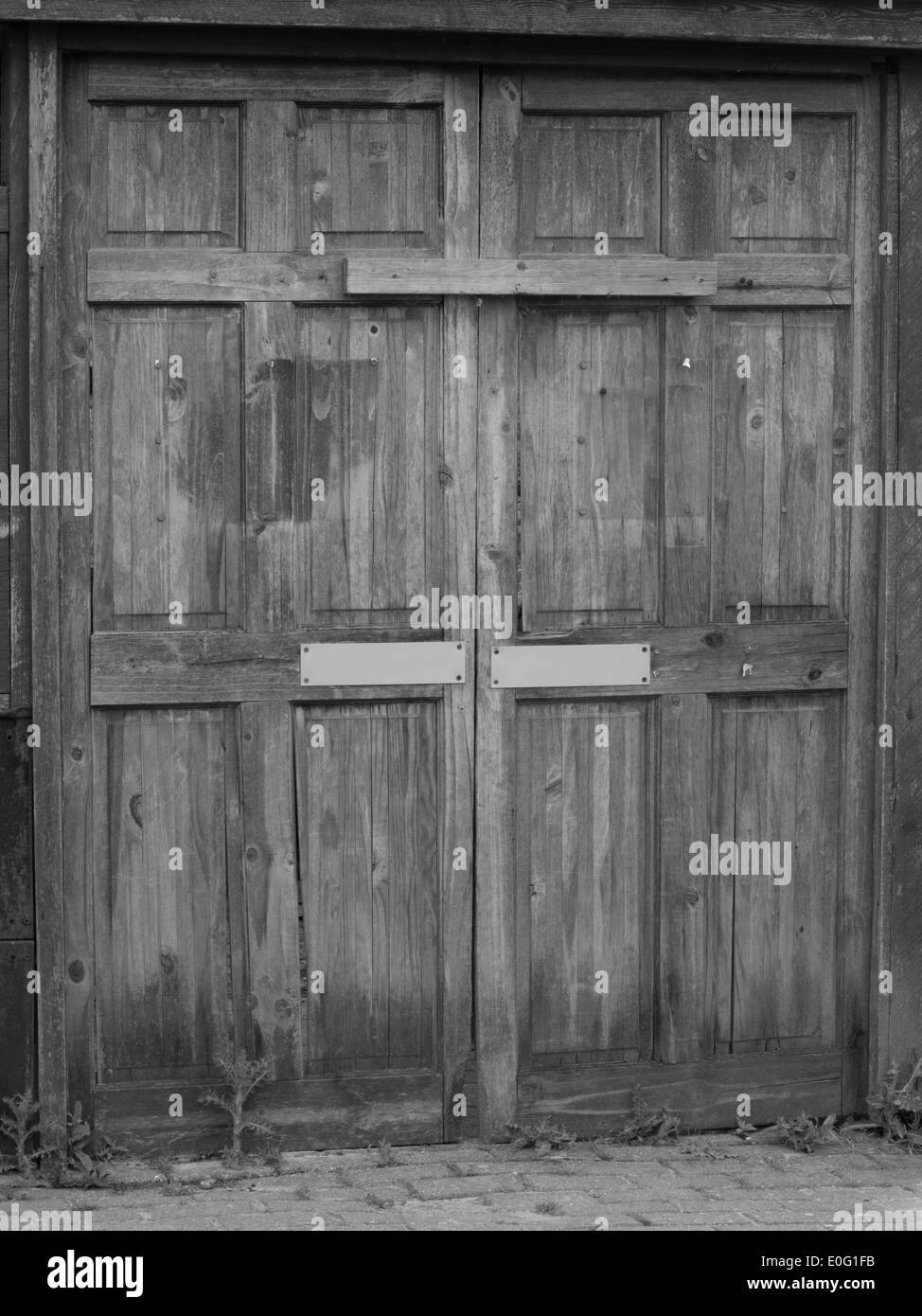 Mono of old double wooden doors. Stock Photo