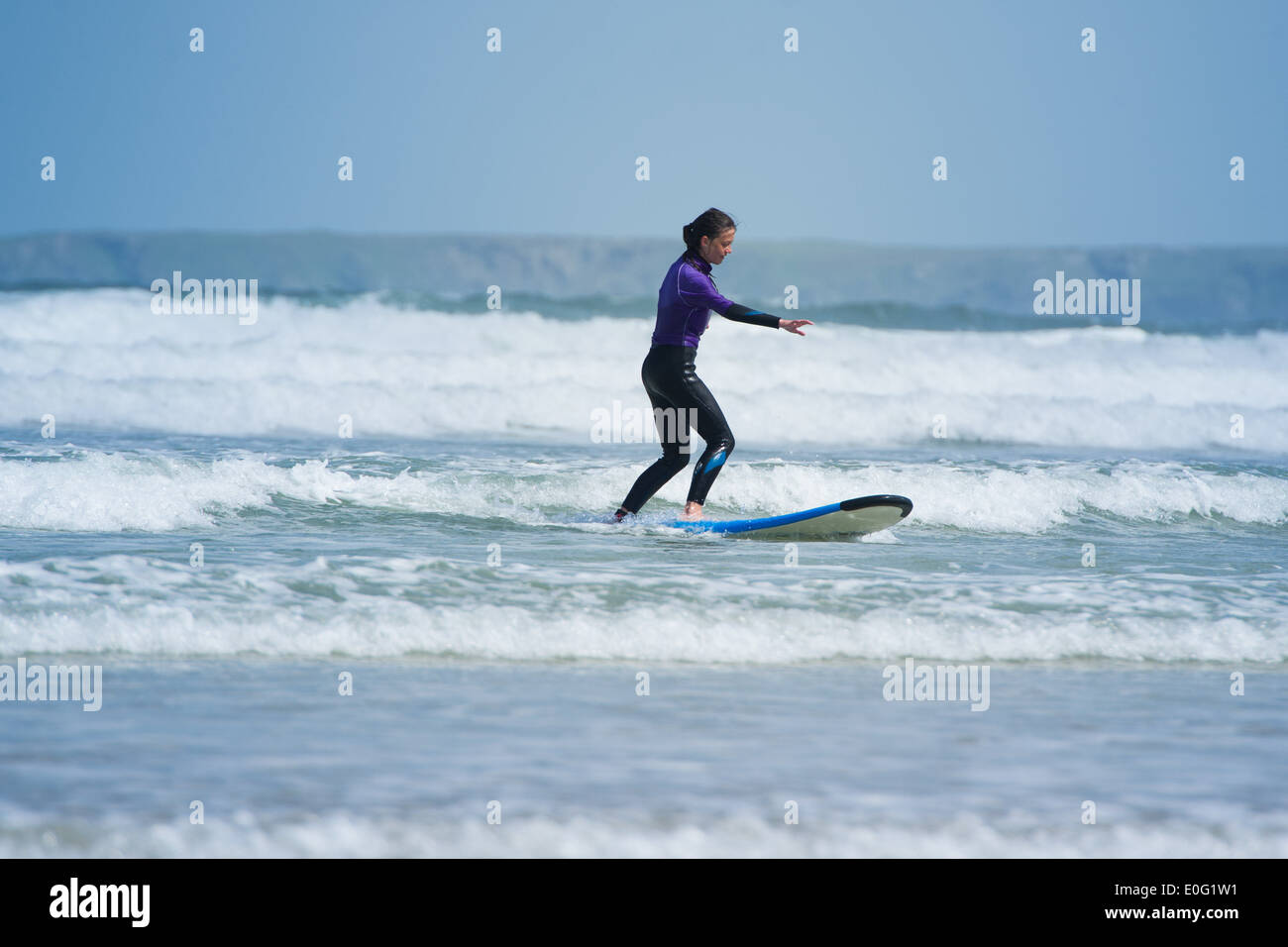 A young female surfer in Newquay, Cornwall, England. Stock Photo