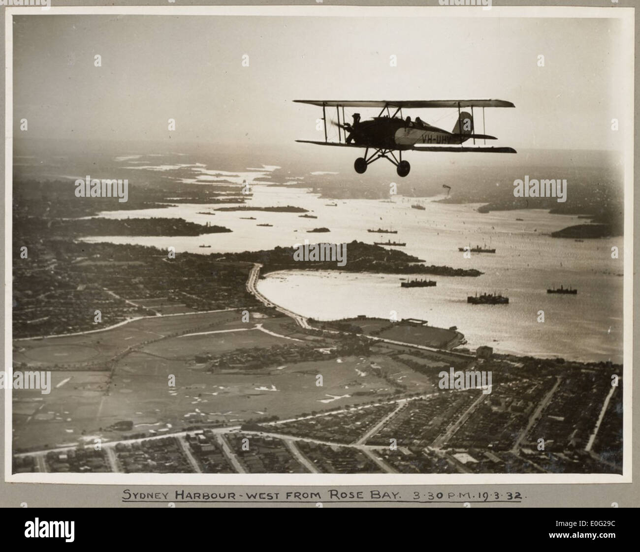 American Eagle model A-1 biplane VH-UHV in flight above Sydney Harbour, 19 March 1932 Stock Photo