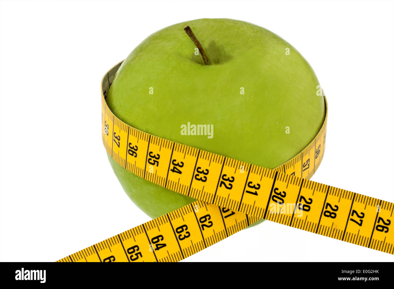 An apple with dimension tape. Symbol for diet with fruit., Ein Apfel mit Massband. Symbol fuer Diaet mit Obst. Stock Photo
