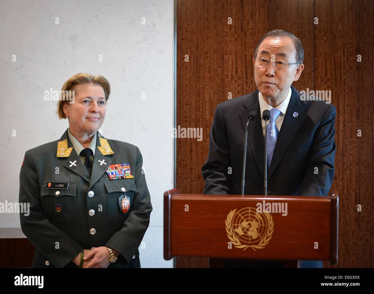 New York, UN headquarters in New York. 12th May, 2014. Major General Kristin Lund (L) looks on as United Nations Secretary-General Ban Ki-moon speaks during a photo opportunity after she was appointed as the commander of the UN peacekeeping force in Cyprus, at the UN headquarters in New York, on May 12, 2014. UN chief Ban Ki-moon on Monday named Major General Kristin Lund to take command of the UN peacekeeping force in Cyprus. The Norwegian commander will be the first female to command a UN force. © Niu Xiaolei/Xinhua/Alamy Live News Stock Photo