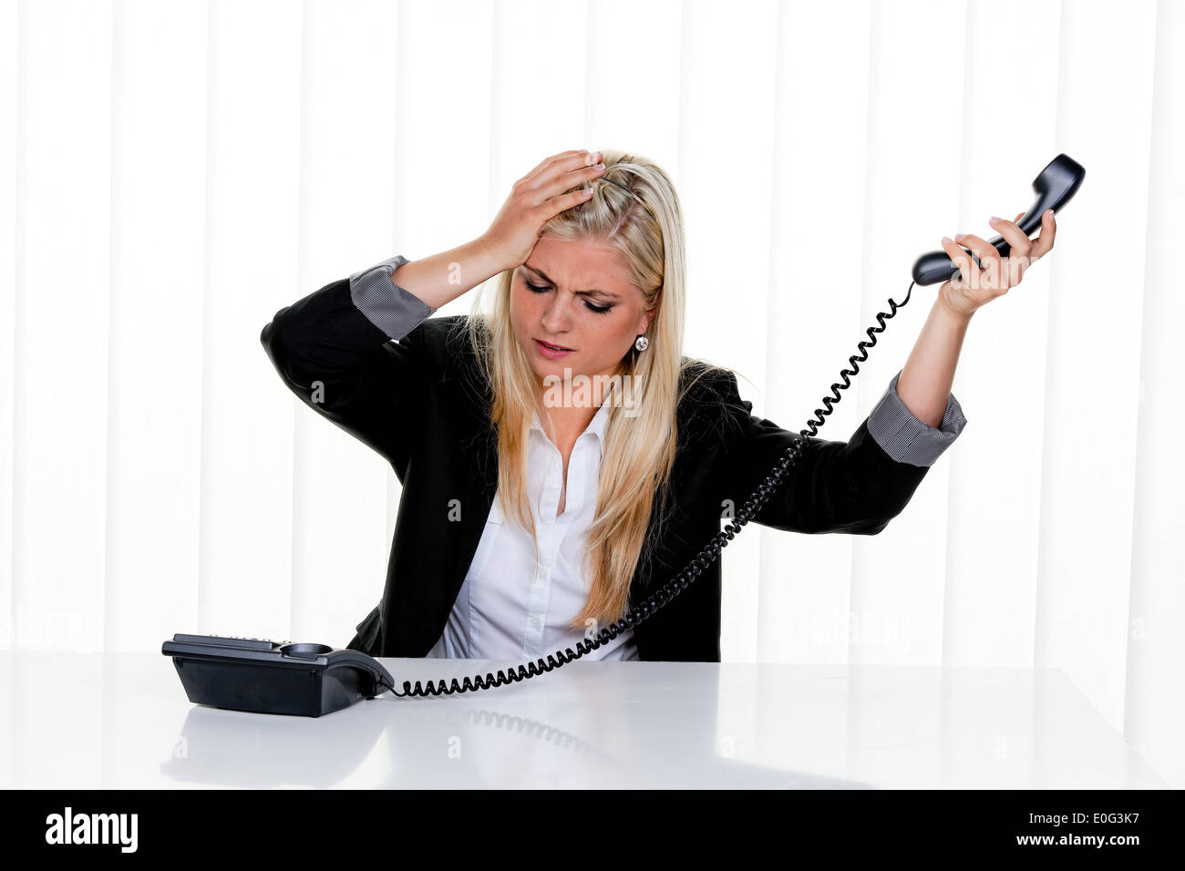 Young woman with problems and stress in the office, Junge Frau mit Problemen und Stress im Buero Stock Photo