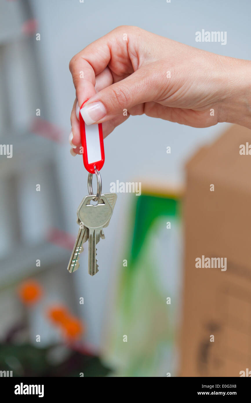 The key of a flat with the move. New tenant enters., Der Schluessel einer Wohnung beim Umzug. Neuer Mieter zieht ein. Stock Photo