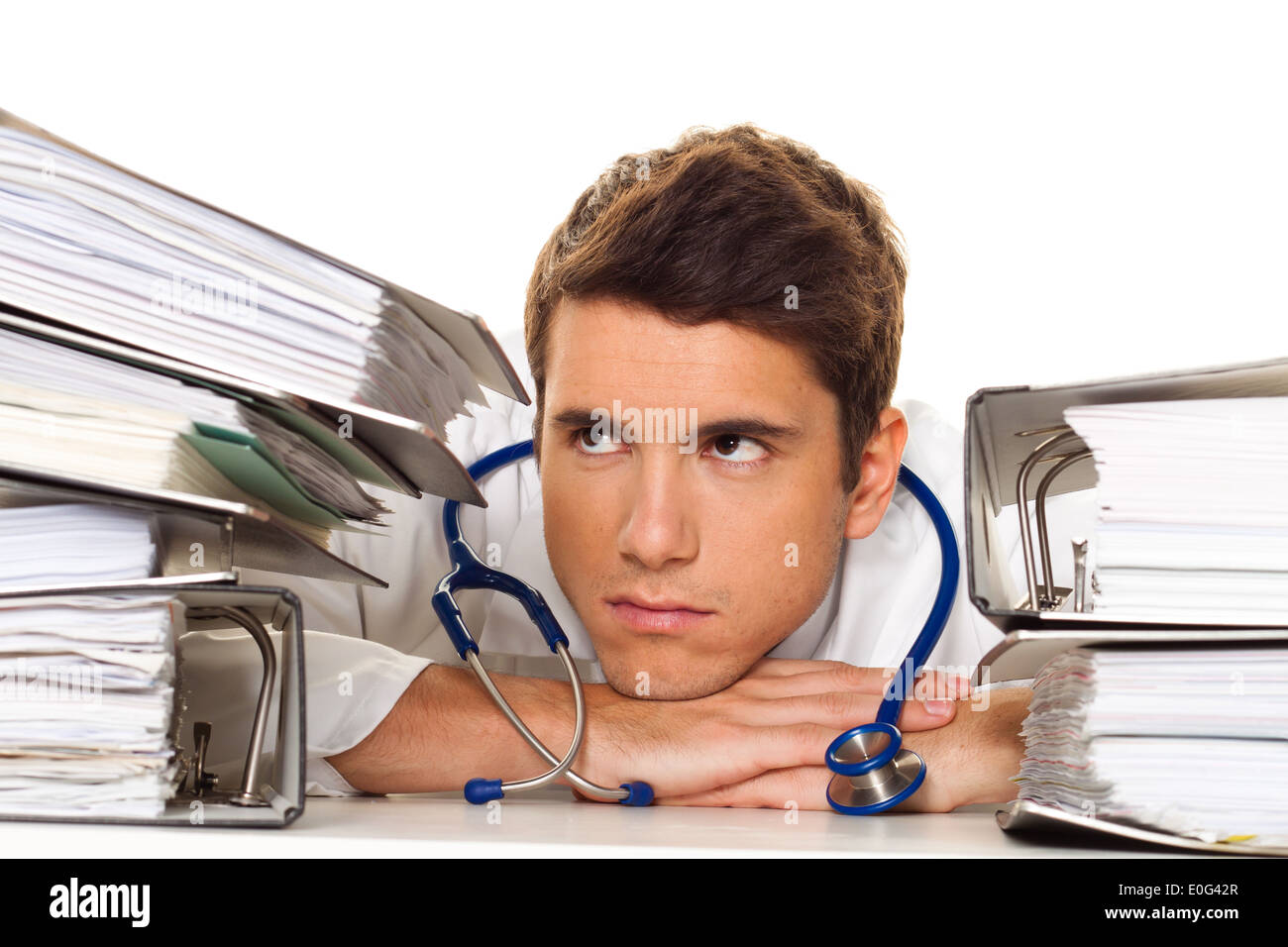 A doctor in the stress with acts pile. Bureaucracy in the hospital., Ein Arzt im Stress mit Akten Stapel. Buerokratie im Kranken Stock Photo