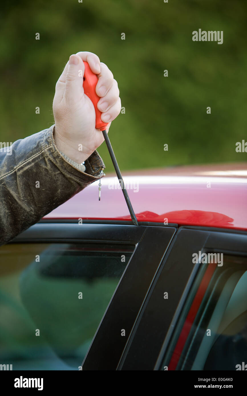 Burglar at a car carbreaker burglary Stock Photo