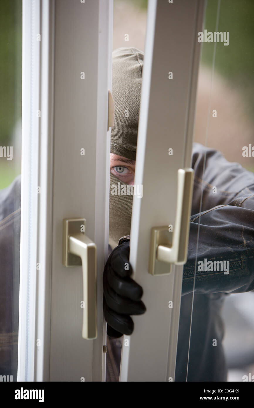 Burglar at a window housebreaker burglary Stock Photo