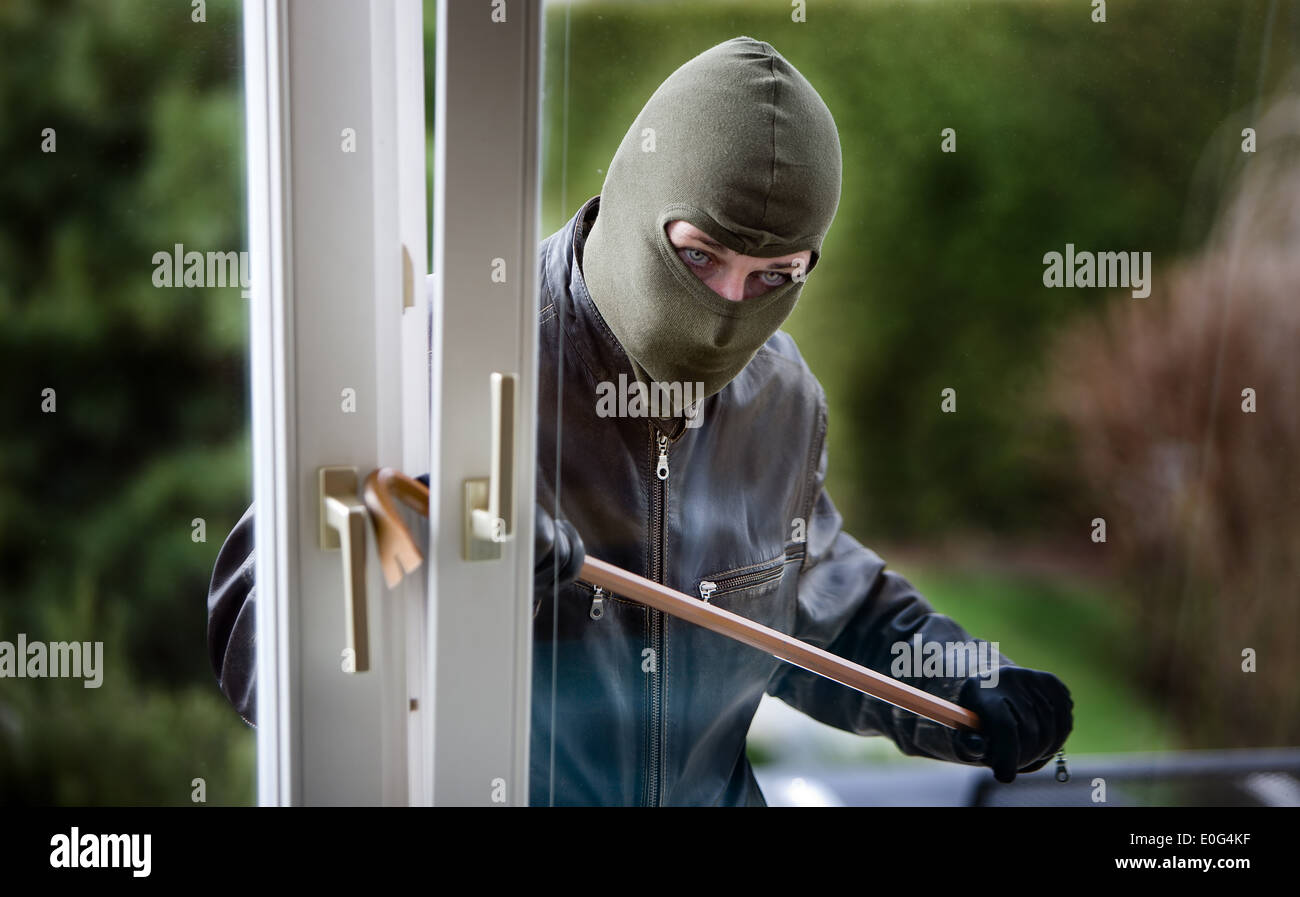 Burglar at a window housebreaker burglary Stock Photo