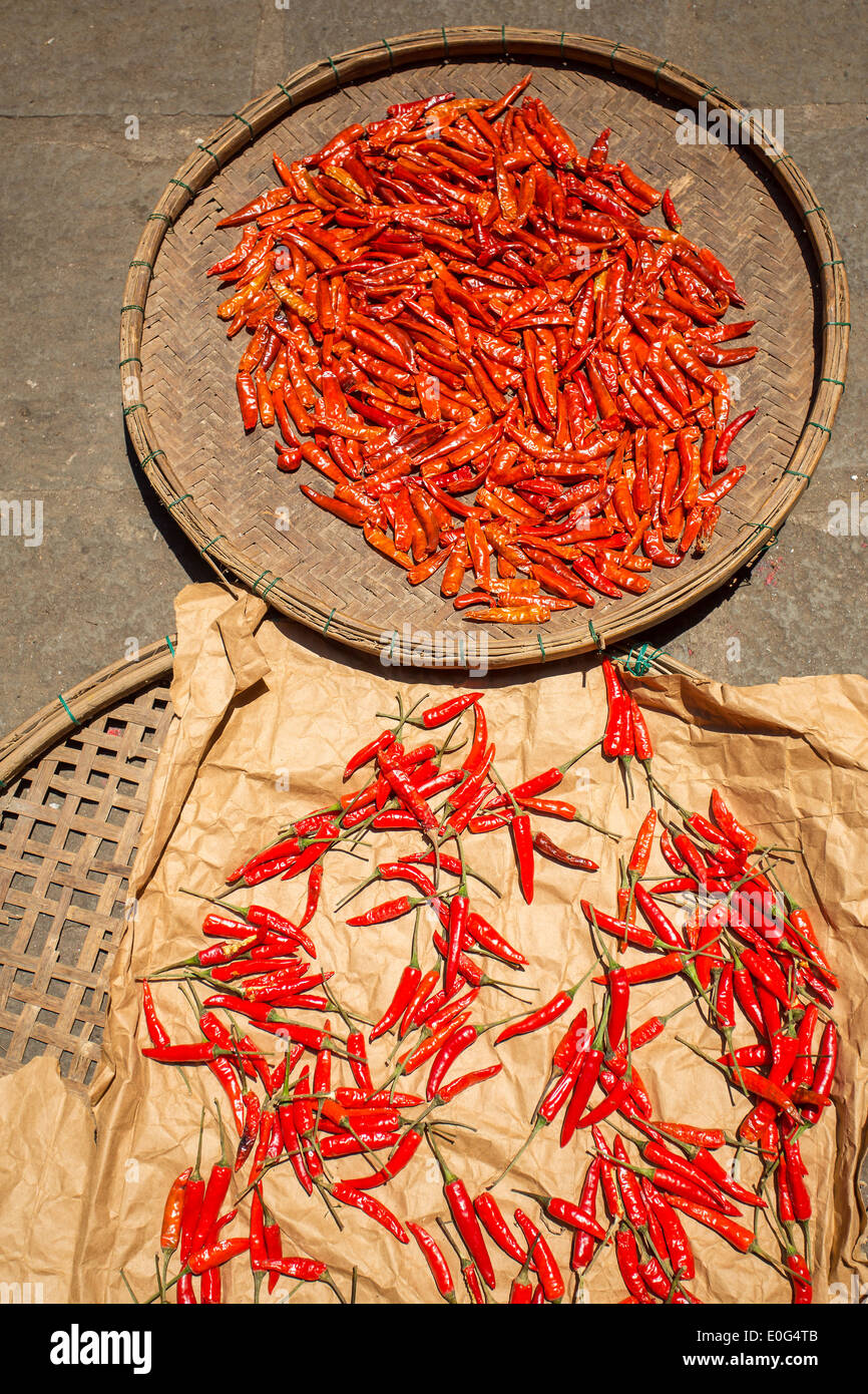 Red chilli pepper drying in the sun at the market Stock Photo
