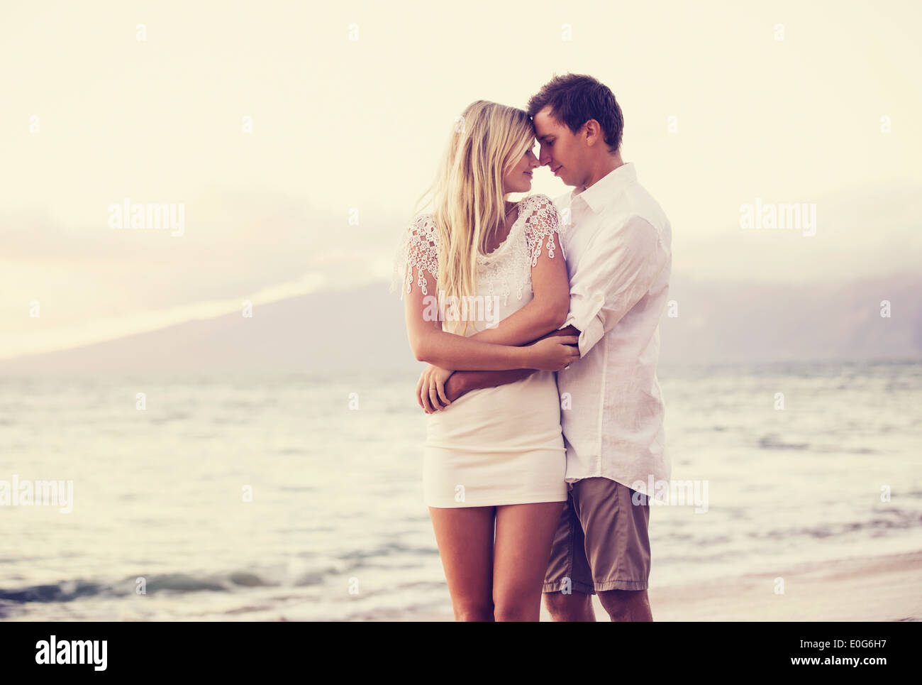 Romantic couple in love on the beach at sunset Stock Photo Alamy