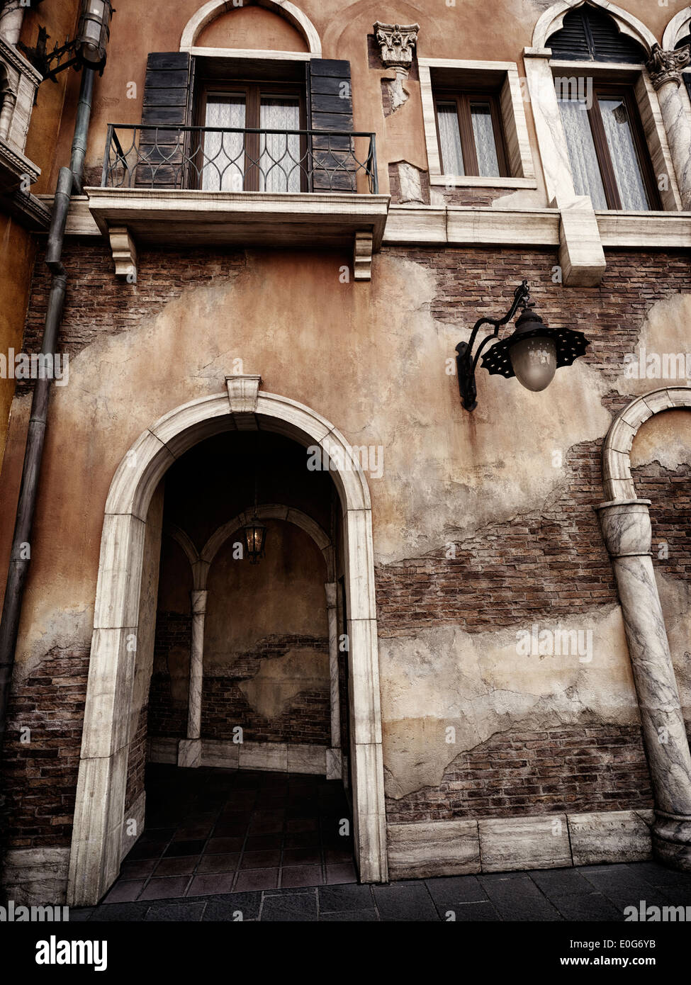 Archway passage in an old rustic building in Venetian gothic architectural style Stock Photo