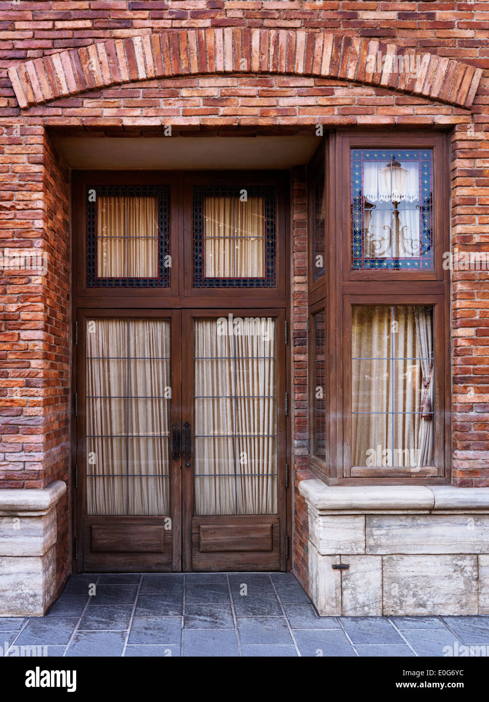 Vintage wooden door of old brick Venetian house Stock Photo