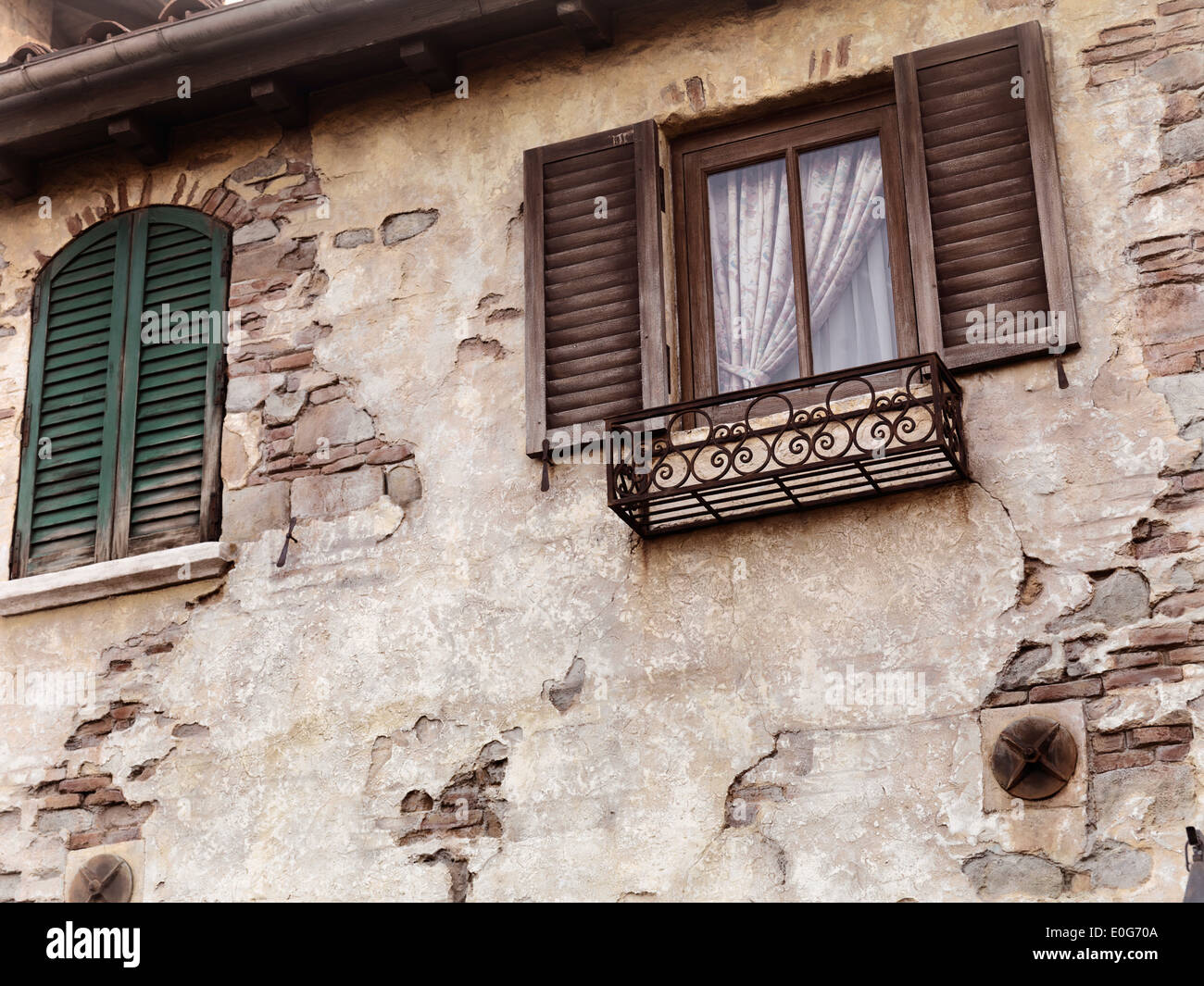Old rustic house windows, antique architecture in Venetian style Stock Photo