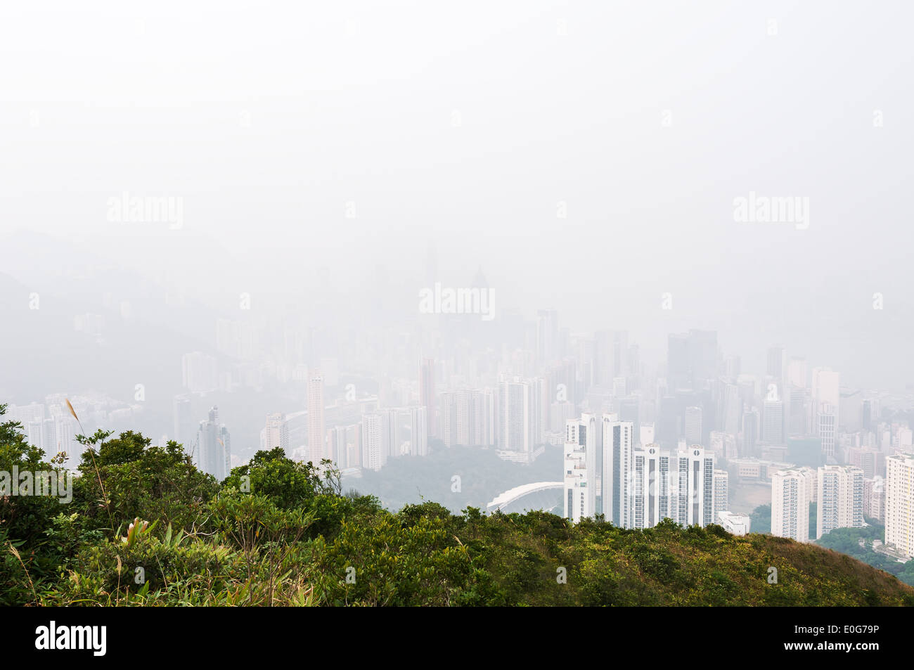 Hong Kong island obscured by haze, as seen from the hills above Happy Valley Stock Photo