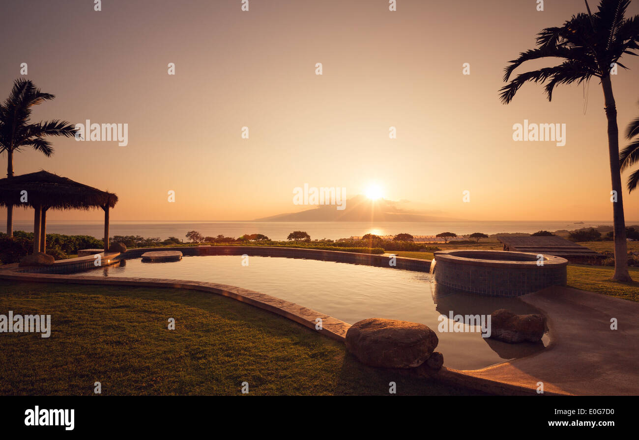 Luxury home with swimming pool at sunset Stock Photo